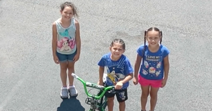 Children Raise Money One Cup at a Time to Buy Bikes for Their New Friends 