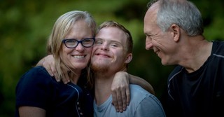 Mom, dad and son hugging