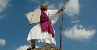 Moses holding tablets on mountain top