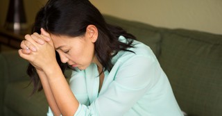 Woman bowing head in prayer