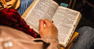 Woman reading an open Bible