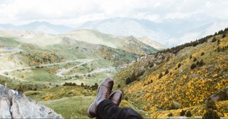 Feet crossed looking over a mountain view