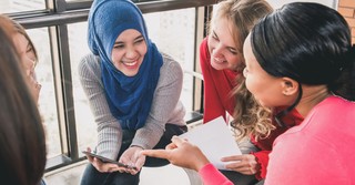 group of diverse women talking and laughing