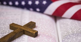 A cross the Bible and the American flag