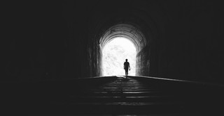 man walking in tunnel