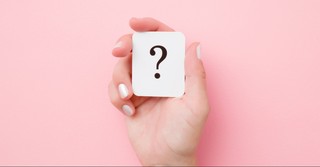 Hand holding a question mark card
