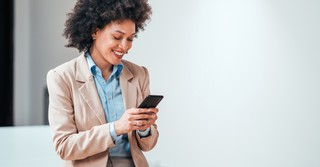 woman smiling at social media on her phone