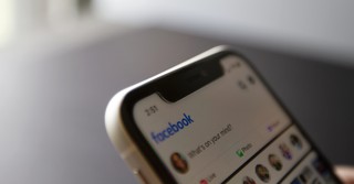 Close-up of a cell phone browsing Facebook