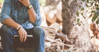 A pondering man with a Bible in the woods, Leading in unprecedented times