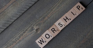 scrabble tiles spelling the word worship
