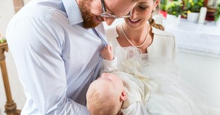 young couple holding baby in church for dedication or baptism, fearfully and wonderfully made