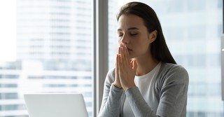 business woman praying for better days ahead