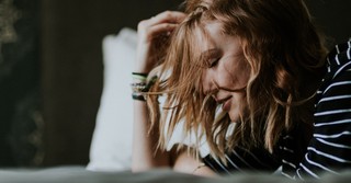 woman with eyes closed thinking and praying for peace and rest, top bible verses to relieve stress