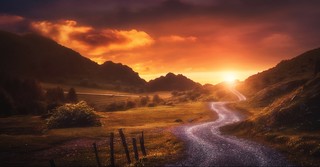 Mountain path leading towards sunrise