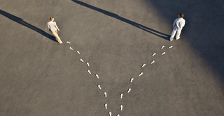 man and woman walking in separate directions