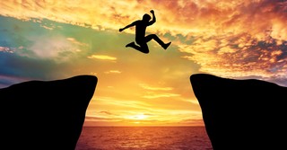 Man leaping over a cliff