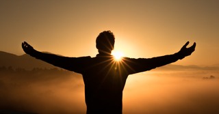 man praising God at sunrise