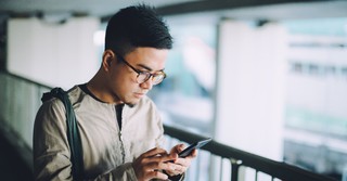 A man looking concerned at his phone