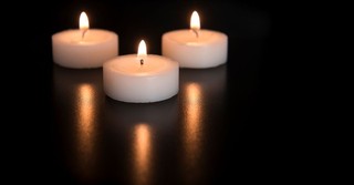 Three tea light candles all lit