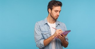 Male reporter taking notes