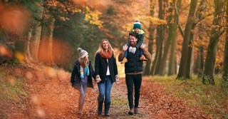 Family walking outside among the Autumn leaves, gratitude walk