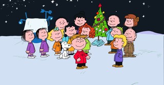 The Peanuts gang gathers around the tree at the end of A Charlie Brown Christmas