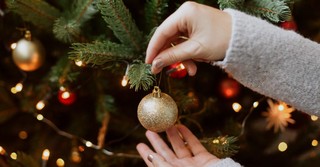 Woman decorating her Christmas tree