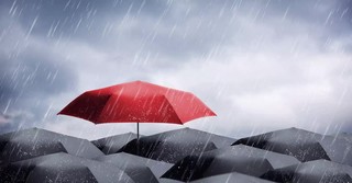 Red umbrella keeping the rain off black umbrella