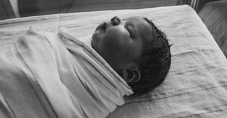 a sleeping and swaddled baby
