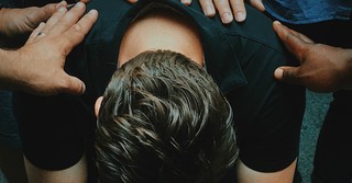 man praying community