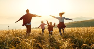 Family running in a field