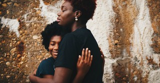 Mom tenderly hugging her child