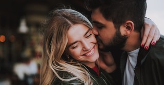Husband kissing his wife on the cheek