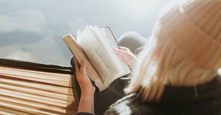 Woman reading Bible outside