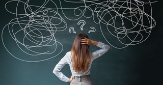 Confused woman looking at jumble of lines