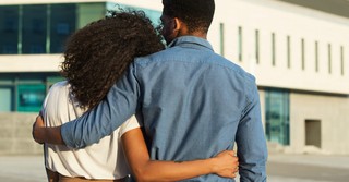 Back view of a man and woman hugging