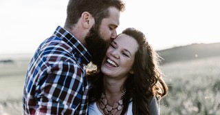 Man giving his wife a kiss on the cheek