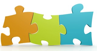 Three different colored puzzle pieces fitting together