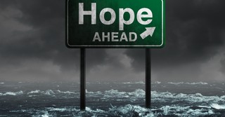 Road sign in the midst of a flood that says hope ahead