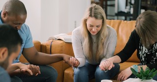 Group of adults praying together