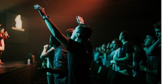 Man with arms raised in worship