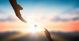 Silhouette of a hand reaching up and one reaching down, with a cross in the background
