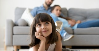 Young girl laying happily on the carpet