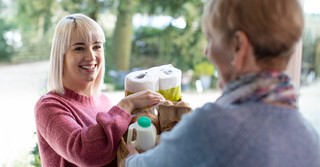 Woman helping her neighbor with groceries