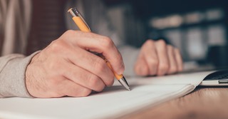 a person writing a list