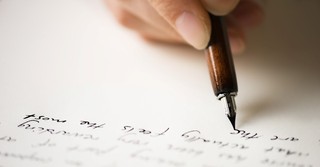 hand writing a letter