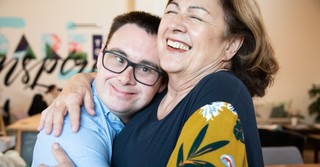 Woman hugging a man with Down syndrome