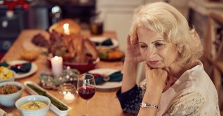 Woman looking upset at Thanksgiving table