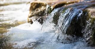 water flowing over a rock