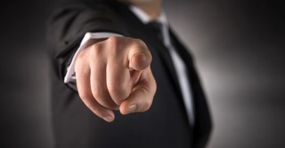 Close up shot of a finger pointing at someone, accusing them